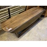 A reproduction oak drop flap coffee table, width 150cm, depth 45cm, height 43cm