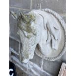A weathered reconstituted stone model of a horse's head, height 60cm