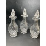 A set of three facet cut glass decanters and stoppers, early 19th century, 27.5cmCONDITION: Andrew