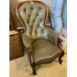 A Victorian carved and moulded showood frame spoonback armchair on scrolled legs, upholstered in