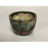 A Chinese bronze lobed censer, 18th century, archaistic cast band, on four disc feet, 11cm diameter