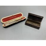 A 19th century papier mache faux tortoiseshell snuff box and a tortoiseshell case containing lace