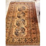 An Afghan rust ground rug, 207 x 131cm