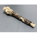 A Dieppe carved ivory pipe tamper, length 11cm