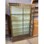 A gilt brass and plate glass collector's display cabinet, width 102cm, depth 33cm, height 162cm
