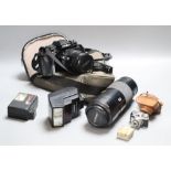A Minolta 9000 SRL camera, a Minolta 75-300 zoom lens, with flash, together with a Sanwa Mycro