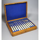 A set of twelve Victorian plated engraved carved bone handled fish knives and forks, cased