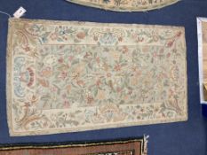 An Antique chainstitch rug, with central field of flowers on a pale blue ground, 122 x 70cm