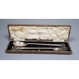 A cased George V Arts and Crafts silver pickle fork and spoon, Cooper Brothers & Sons, Sheffield,