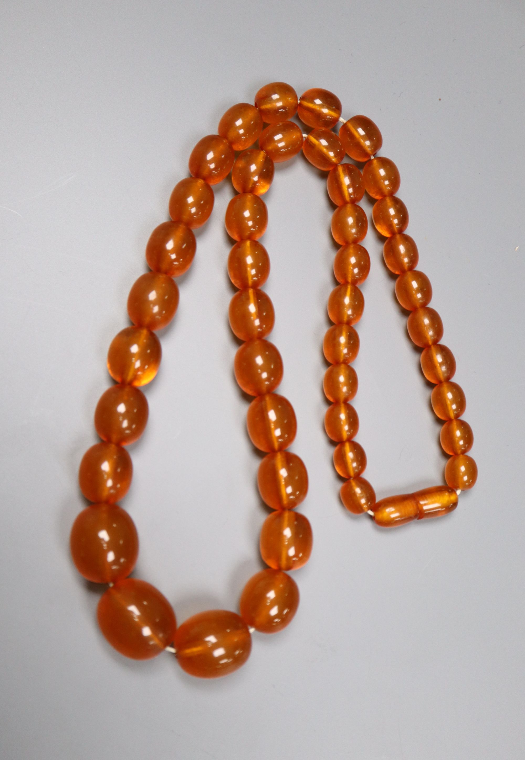 A single strand graduated oval amber bead necklace, 52cm, gross 42 grams. - Image 2 of 2