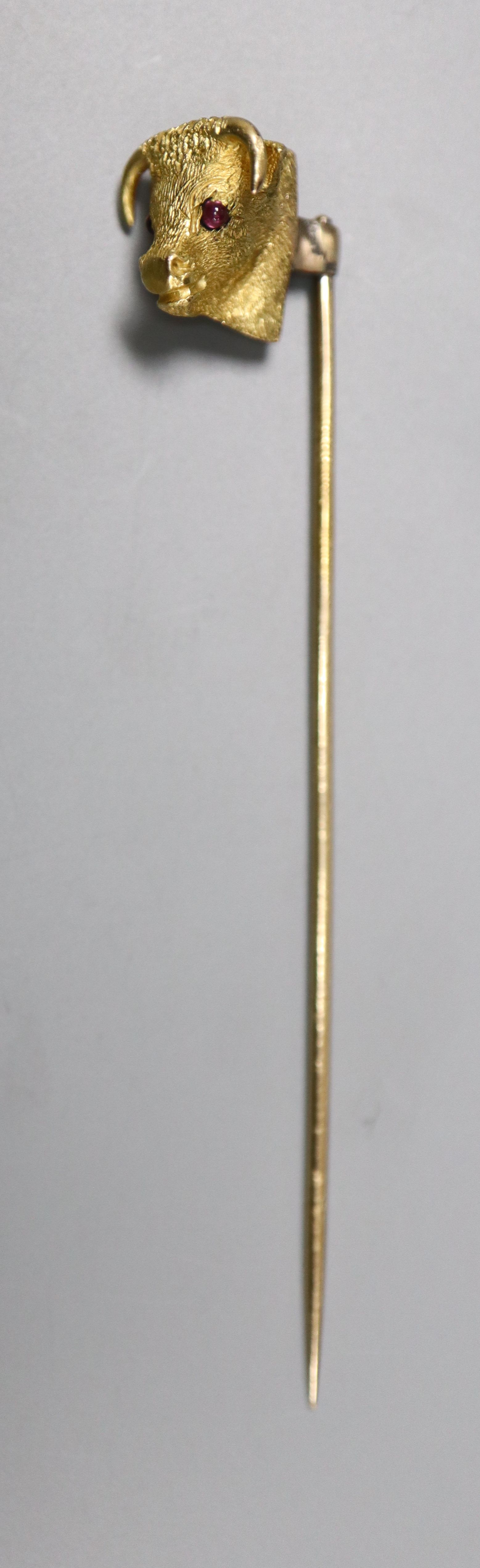 An Edwardian yellow metal and garnet set 'bull's head' stick pin, 65mm, gross 4.4 grams.CONDITION: - Image 2 of 3