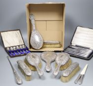 A late Victorian repousse silver mounted seven piece dressing table set by William Comyns, London,