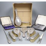 A late Victorian repousse silver mounted seven piece dressing table set by William Comyns, London,