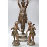 A pair of spelter cherubs, after Bruchon, and another spelter figure, height 74cm