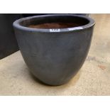 A circular grey glazed garden planter, diameter 36cm height 32cm