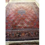 A Hamadan red ground carpet, 422 x 307cm