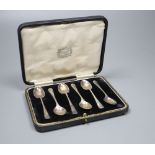 A set of six George V silver coffee spoons with shell terminals, by Thomas Bradbury & Sons, cased.