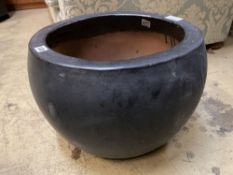 A circular grey glazed garden planter, diameter 43cm height 33cm