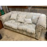 An early 20th century upholstered Chesterfield settee, length 200cm, depth 110cm, height 70cm