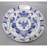 An 18th century blue and white Delft charger, 35cmCONDITION: Shallow chips and flakes to rim, no