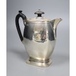 A George V silver hot water pot, with ebonised handle, Carrington & Co, London, 1912, 18.1cm, 16oz.