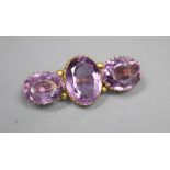 A Victorian gold three stone amethyst bar brooch, 4.25cm, later cased