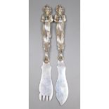 A pair of late Victorian silver fish eaters with figural handles by Goldsmiths & Silversmiths Co