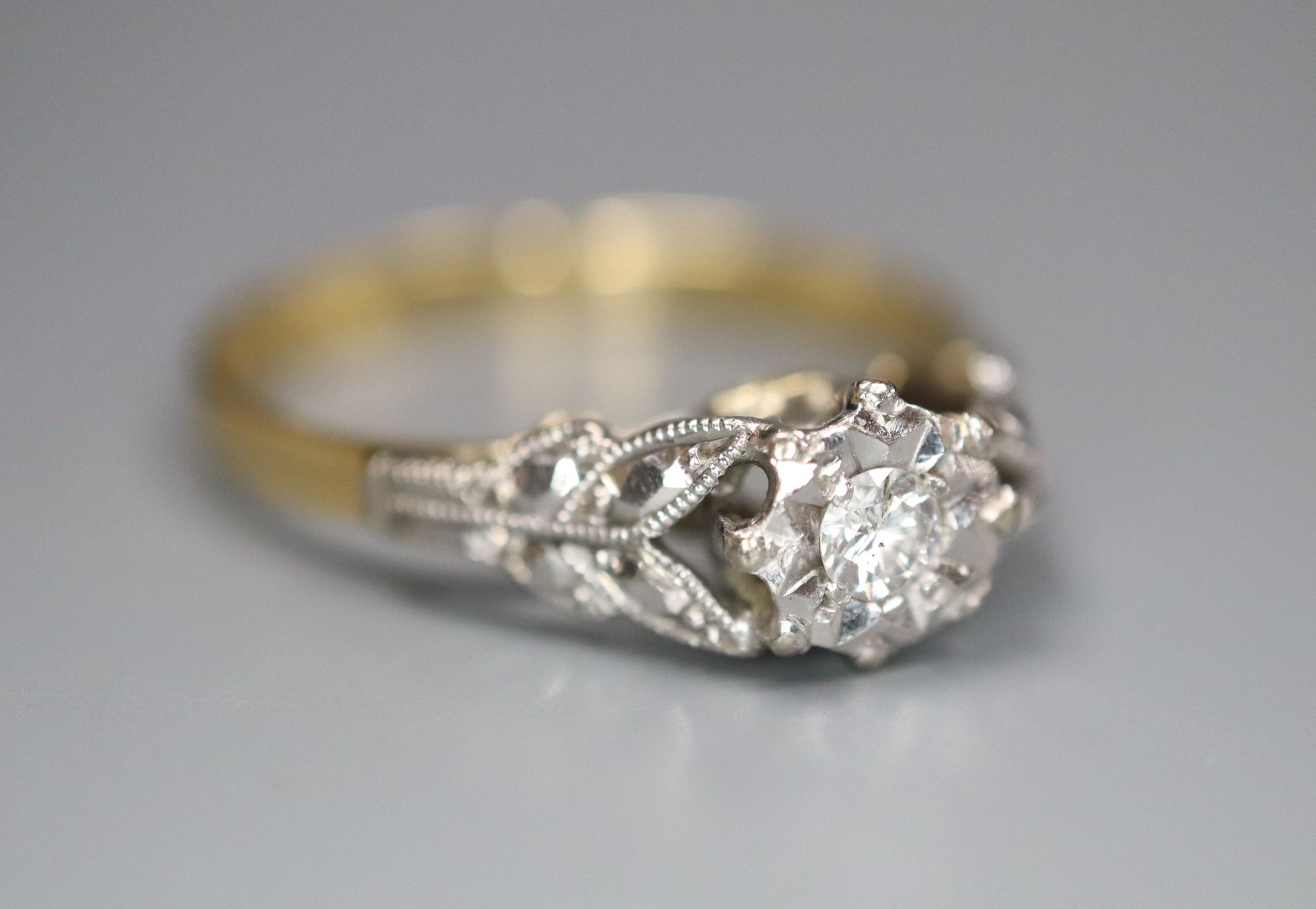 A 1960's 18ct gold and plat, illusion set solitaire diamond ring, size L, gross 2.3 grams.CONDITION: