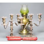 A pair of plated two branch candelabra and a brass oil lamp (3)