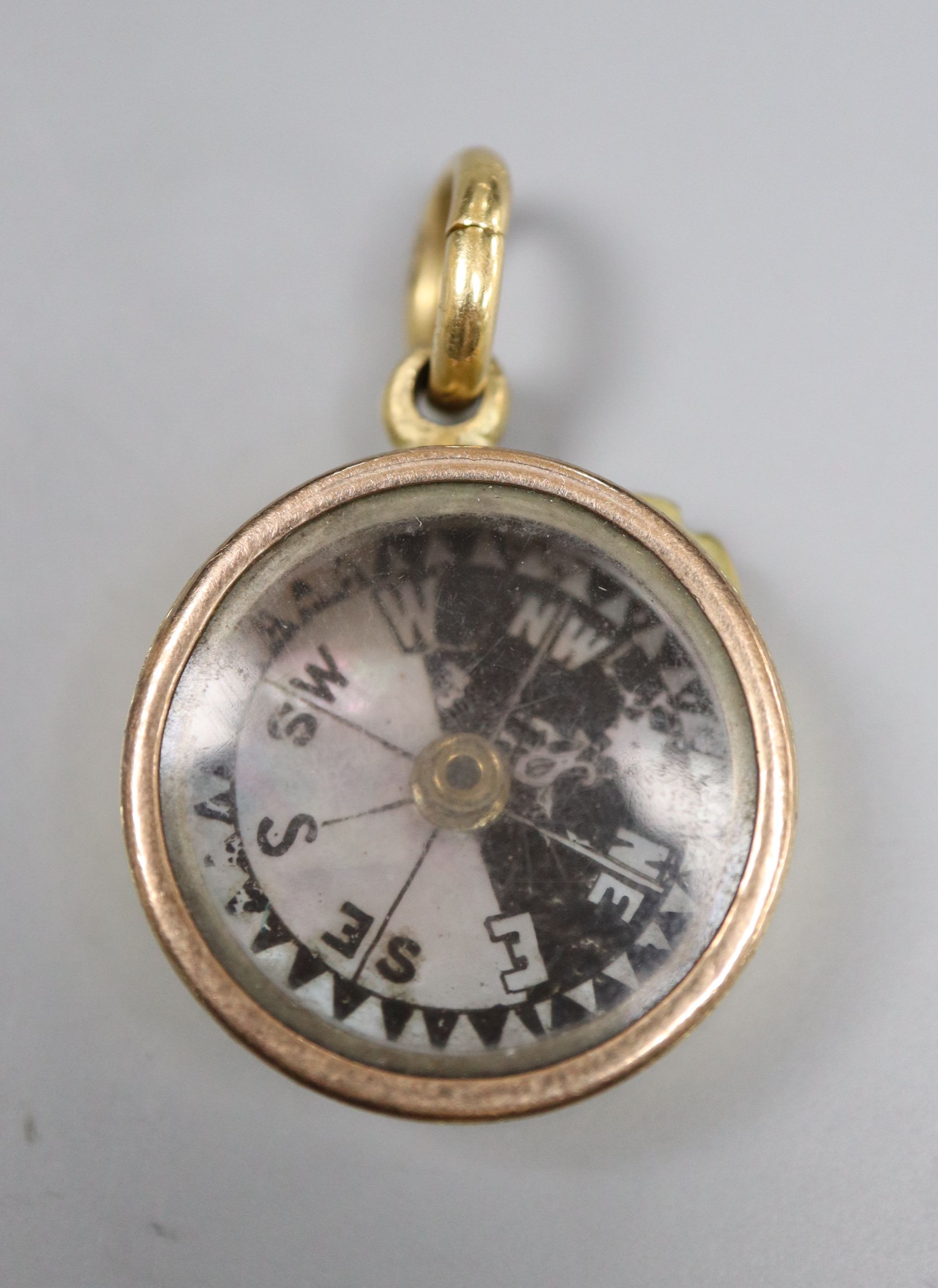 An 18ct cased pendant compass, with bale, 22mm, gross 14 grams.CONDITION: Bale only stamped 18ct.