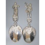 An ornate pair of late Victorian Hanau silver servers with figural handles, modelled as a lady and