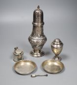 An Edwardian embossed silver sugar caster, 21.2cm, a small Georgian caster, a silver mustard and two