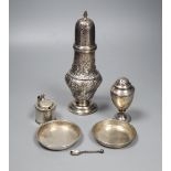 An Edwardian embossed silver sugar caster, 21.2cm, a small Georgian caster, a silver mustard and two