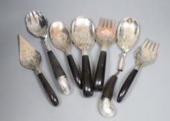 A group of assorted Thai ebony handled engraved white metal servers, one a.f.