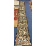 An unusually narrow Hamadan runner, with geometric motifs on a cream ground, 405 x 54cm