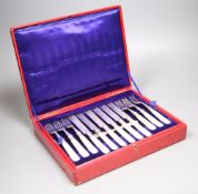 A set of twelve plated engraved mother of pearl handled dessert knives and forks, cased