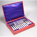 A set of twelve plated engraved mother of pearl handled dessert knives and forks, cased