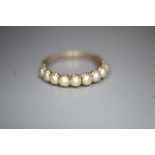 A 19th century gold and split pearl half hoop ring, set with ten pearls, gross 1.6 grams