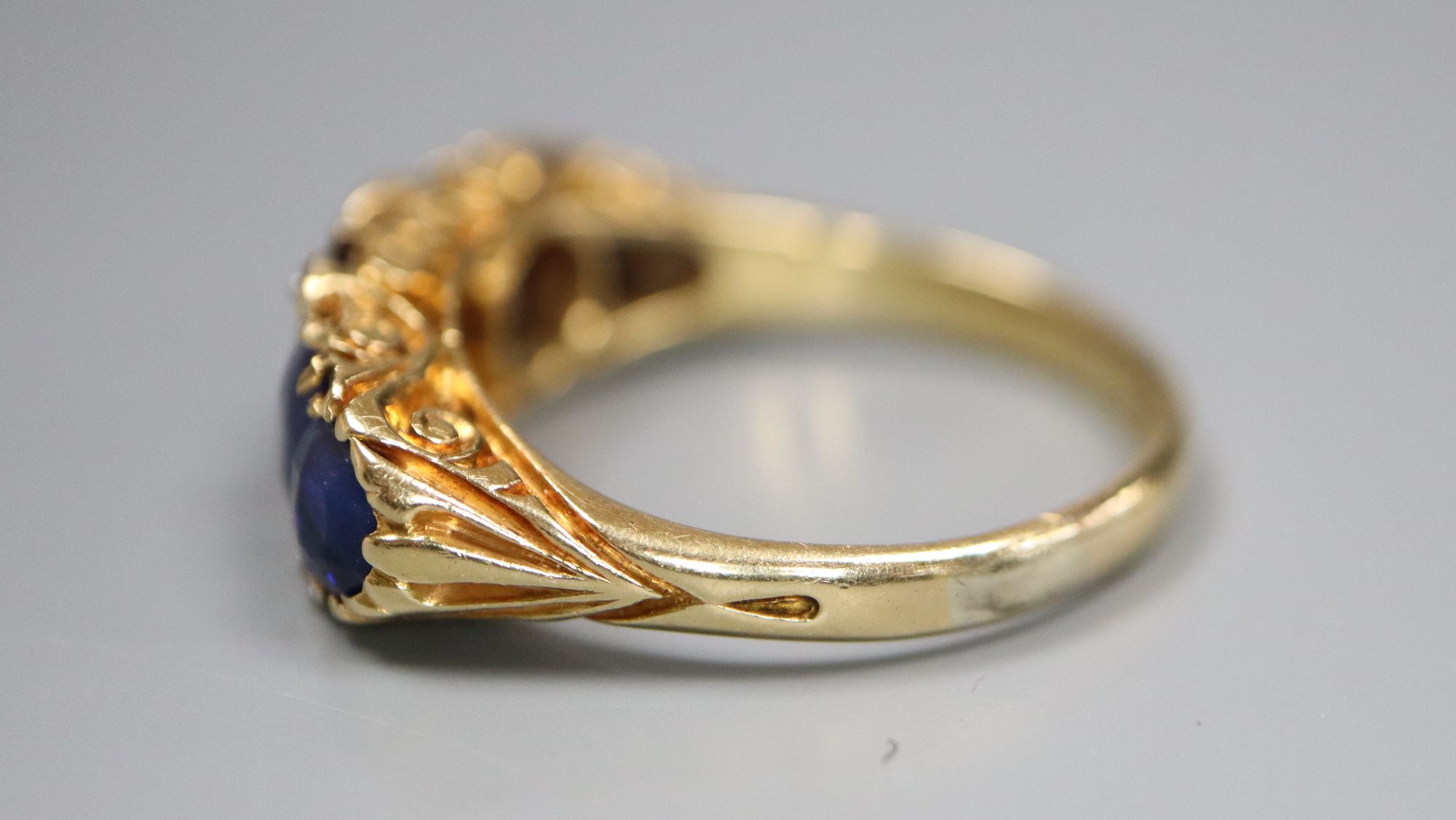 A George V 18ct gold and graduated five stone sapphire set half hoop ring, with diamond chip - Image 2 of 5