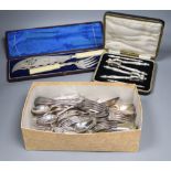 A pair of plated engraved bone handled fish servers, cased and a set of nut crackers, cased and