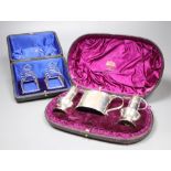 A Victorian silver three-piece condiment set, London, 1882, cased and a pair of small Edwardian