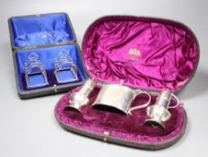 A Victorian silver three-piece condiment set, London, 1882, cased and a pair of small Edwardian