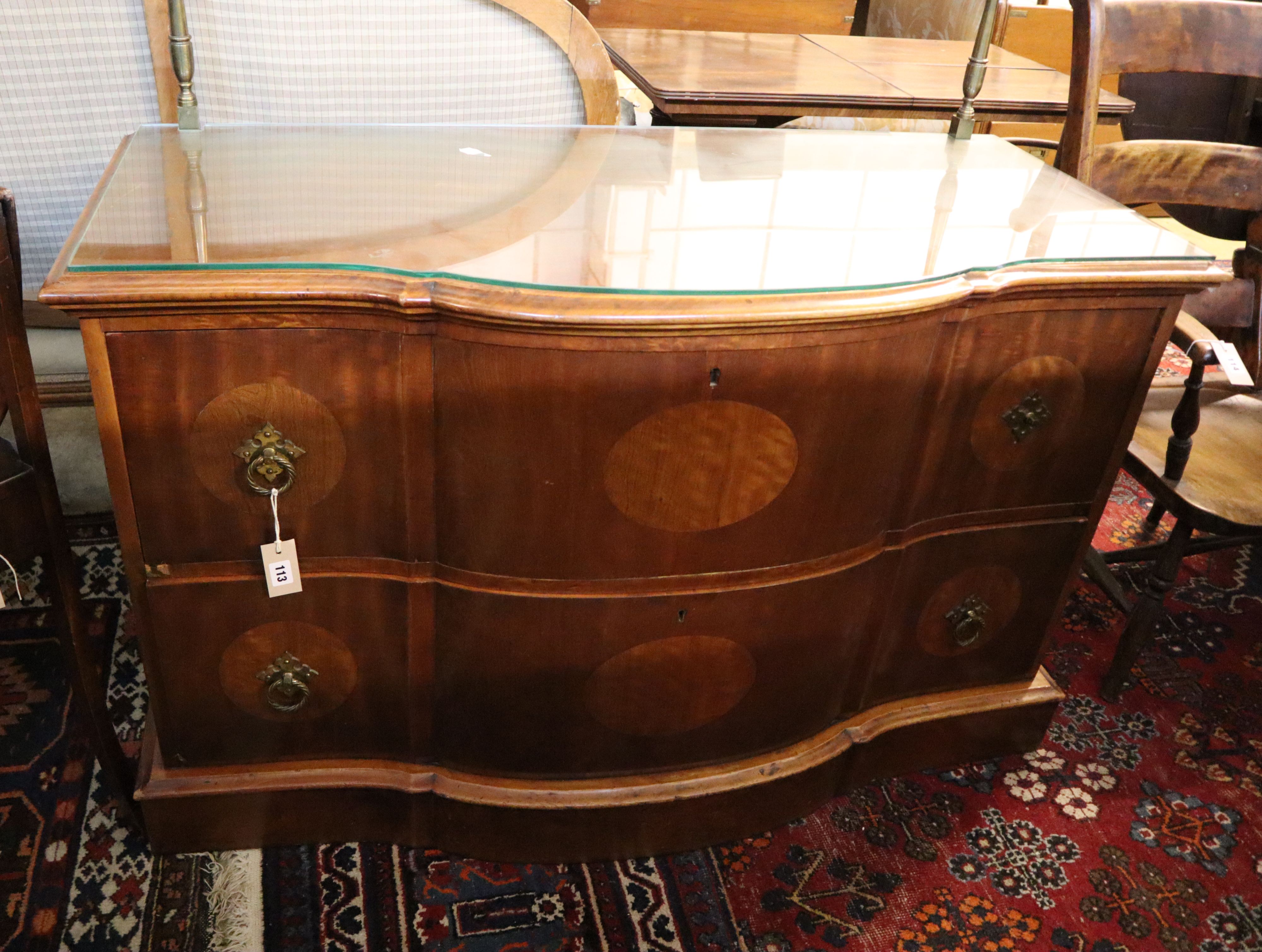 An inlaid walnut chest of shaped form, fitted two long drawers on plinth base, width 124cm, depth