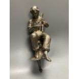 A Victorian silver plated model of a seated tin miner