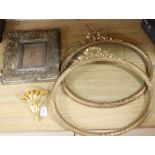 A pair of Victorian ornate gilt gesso oval picture frames, 50 x 55cm, a similar wall shelf and a