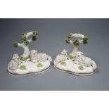 Two similar Staffordshire porcelain models of sheep recumbent beneath a tree, c.1835-50, possibly