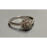 A modern 9ct white gold and diamond cluster ring, size M/N, gross 2 grams.CONDITION: Some wear to