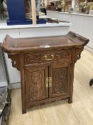 A Chinese carved hardwood side cabinet, fitted one long drawer over a pair of doors, width 70cm