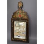 An Indian painted wall mirror, height 46cm