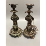 Two patinated metal 'putti' candlesticks, height 20cm